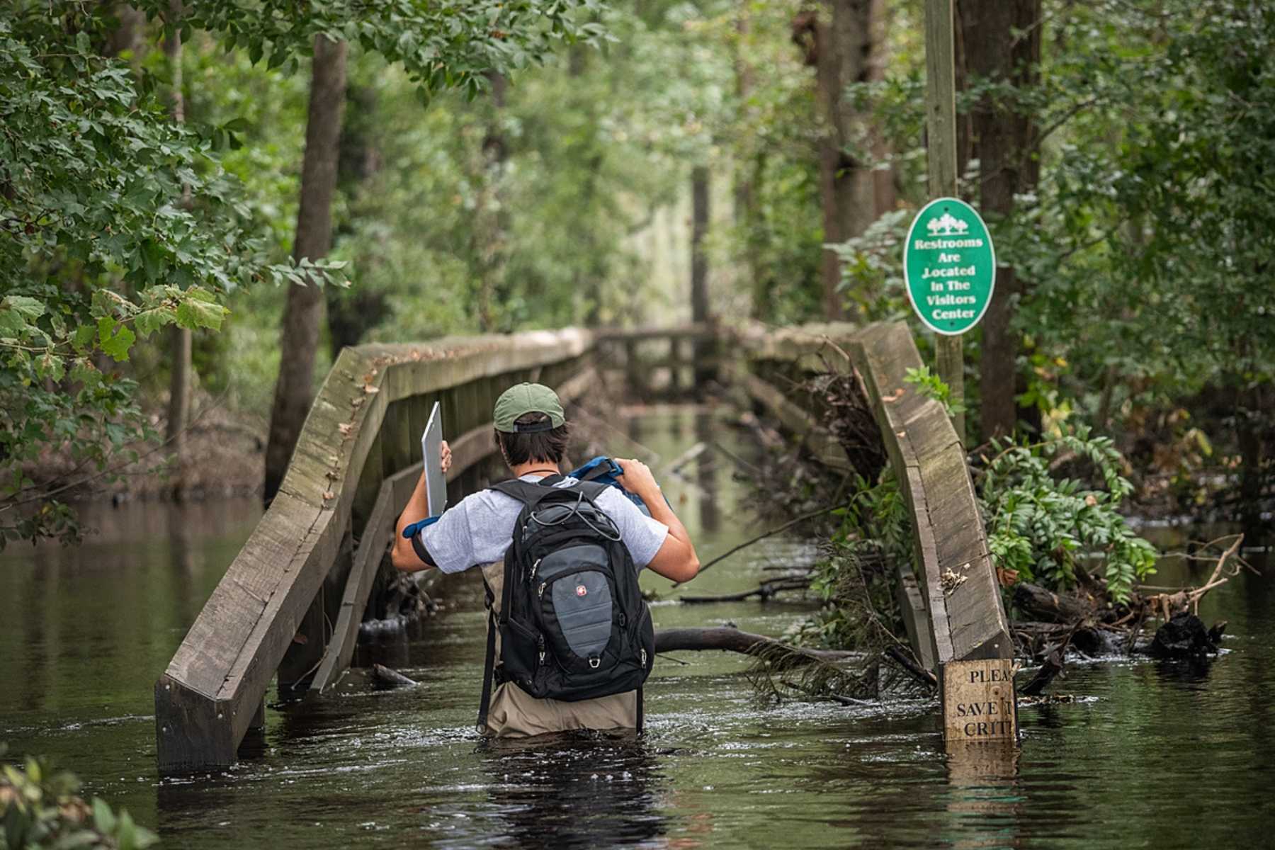 Patrick Connell, a member of Waterkeeper Alliance, walking through a river affected by Hurricane Florence