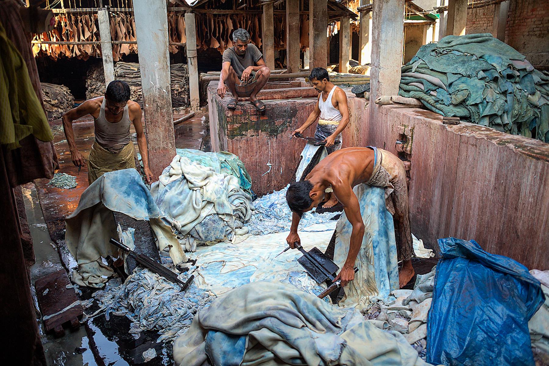 In Hazaribagh, a part of western Dhaka reknowned for its tanneries, several workers scrape the chemicaly dissolved fatty layers from the hides with specially designed knives.